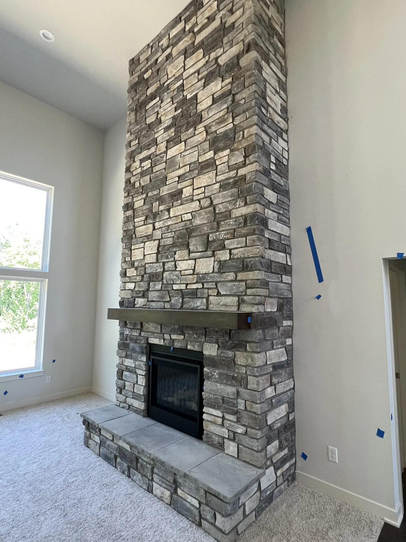 Floor to ceiling interior stone fireplace