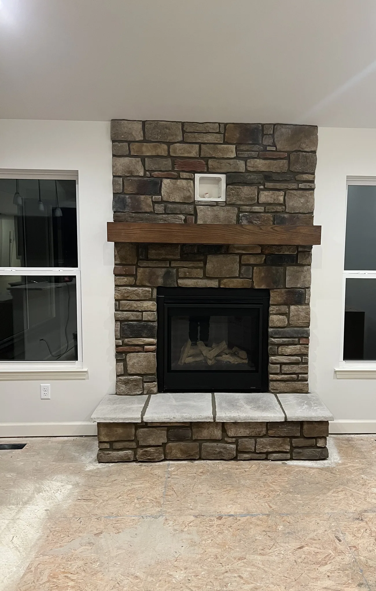 Finished stone fireplace with mantel