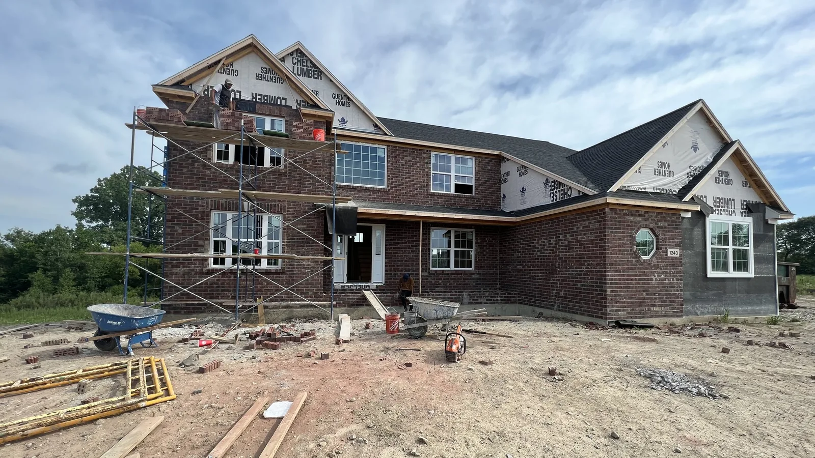 Custom brick home with gables under construction by Twin Brothers Construction